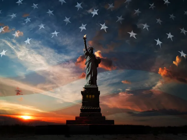 statue of liberty and american flag